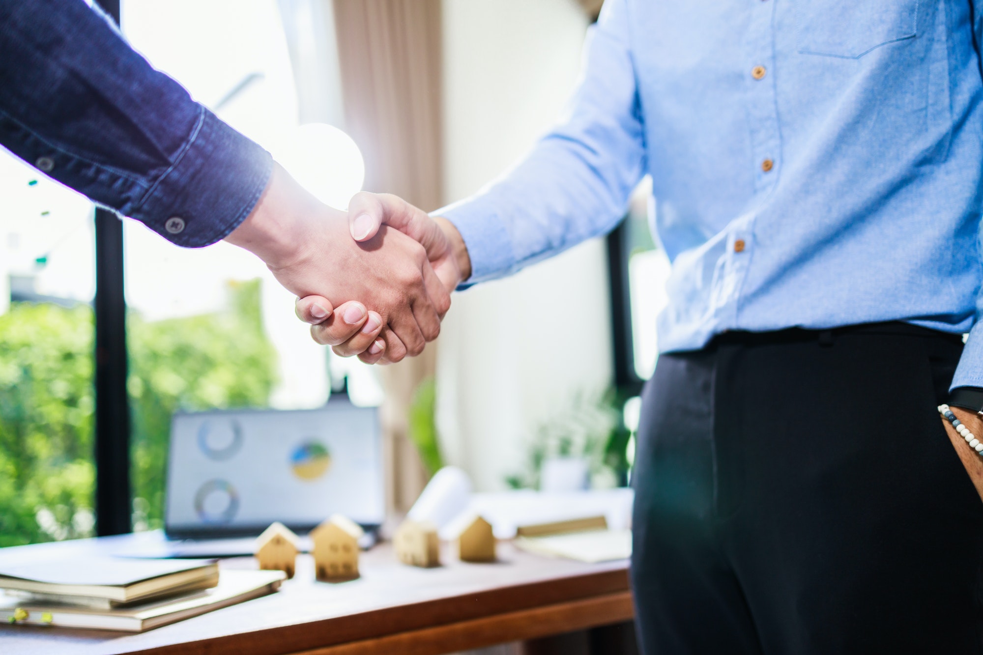 Real estate agent handshake, deal business. Business partnership meeting and home insurance